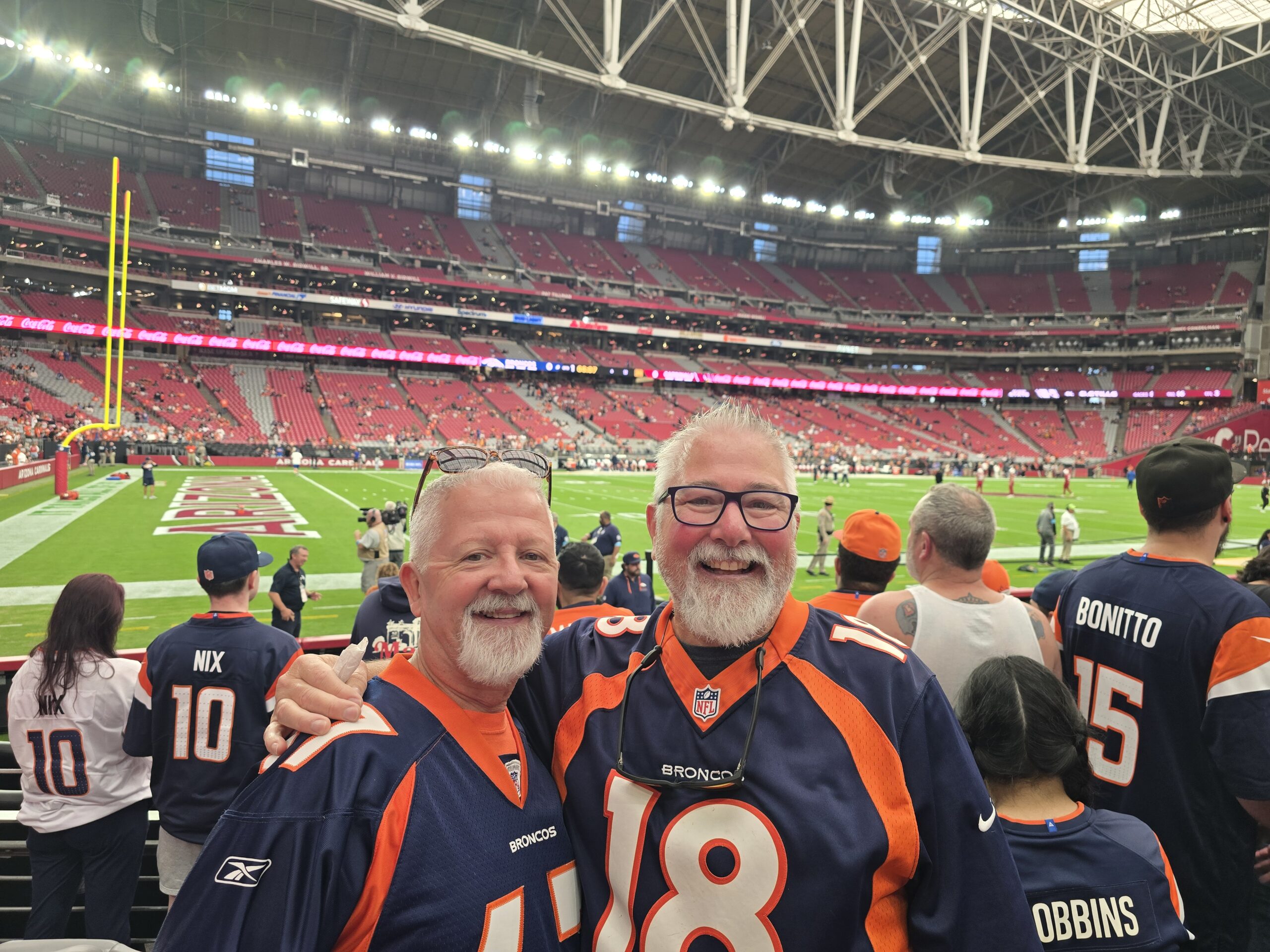 Tracey and his brother Scott in Broncos jerseys at the Broncos vs Cardinals game
